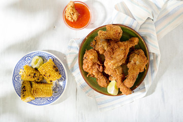 Chicken leg with grilled corn and red spicy sauce