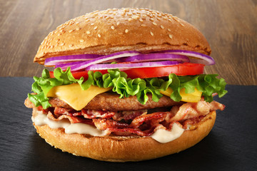 Home made hamburger with lettuce, cheese and bacon.