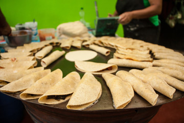 Quesadillas, Mexican food: hand-made tortillas filled with cheese, chicken, potatoes or chorizo, served with green and red salsa