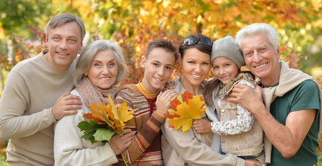 Family relaxing in autumn park