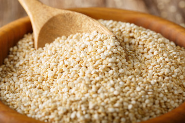 Dry white quinoa in a bowl macro. horizontal background