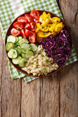 Vegetarian meal salad with organic vegetables and quinoa close up. Vertical top view