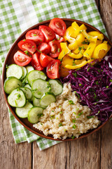 salad from quinoa with red cabbage, tomatoes, pepper and cucumbers close-up. Vertical top view
