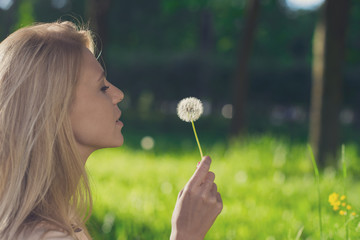 Beautiful blond with a dandelion
