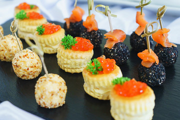 Tapas, canaps, sandwiches, rolls with red fish prepared for the visitors of the event. 