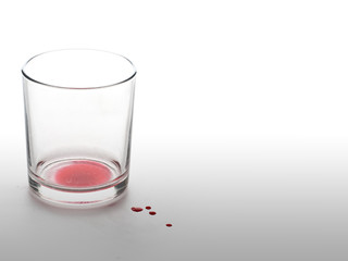 Empty glass with red drink. Emptiness inside concept.