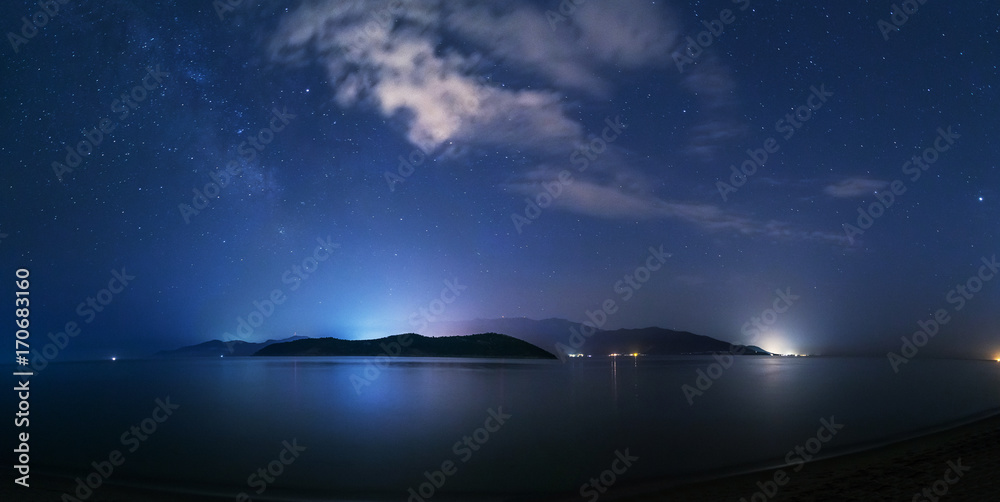 Wall mural night starry sky on the beach in keramoti, greece