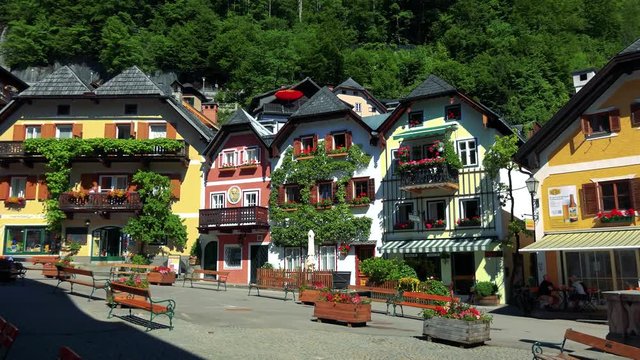 Famous square with old houses in Hallstatt village in summer day