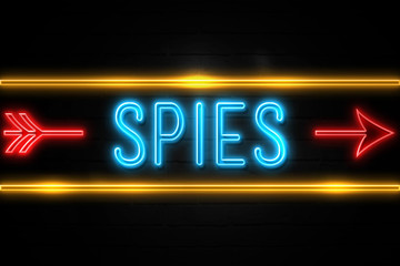 Obraz premium Spies - fluorescent Neon Sign on brickwall Front view