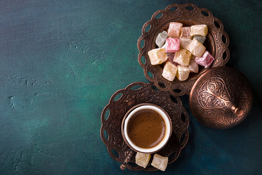 Fototapeta Traditional turkish coffee  and turkish delight on dark green wooden background. flat lay