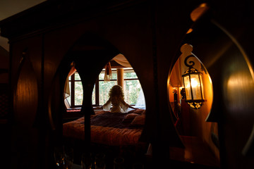 silhouette of the bride sitting on the bed