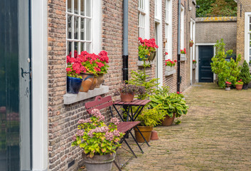 Fototapeta na wymiar Facades in the historic beguinage in the Dutch city of Breda. The beguinage is a National Monument.