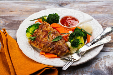 Fried pork steak with vegetables garnish. Copy space