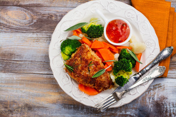 Fried pork steak with vegetables garnish. Copy space
