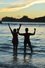 Fototapeta premium Senior couple jumping on seashore 