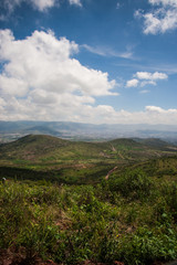 Fototapeta premium Green, mountainous landscape in Central Mexico under clouded, blue sky