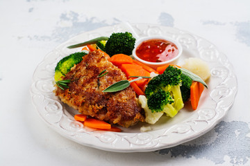 Fried pork steak with vegetables garnish. Copy space