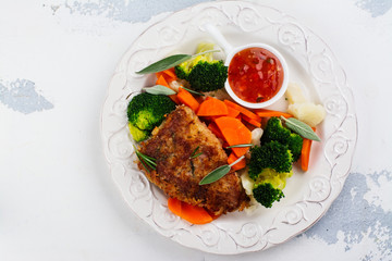 Fried pork steak with vegetables garnish. Copy space