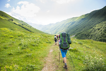 Hiking in beautiful mountains. Group of hikers enjoy the weather