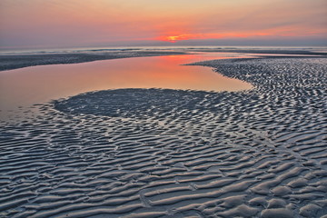 The beach of Ambleteuse at sunset with patterns on the sand in the foreground, Cote d'Opale, Pas de...