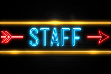 Staff  - fluorescent Neon Sign on brickwall Front view