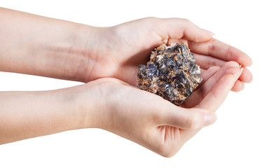 side view of zinc and lead mineral ore in handful