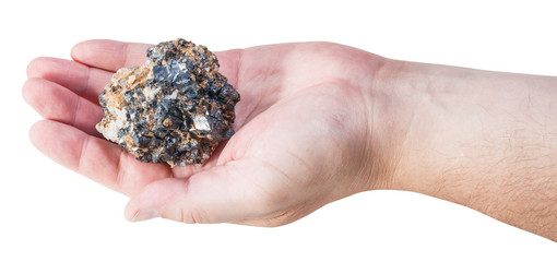 piece of zinc and lead mineral ore on male palm