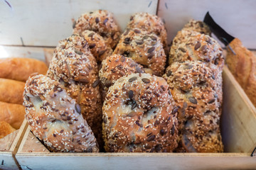 Fresh brown buns with sesame and sunflower seeds  for sale at local farmers market