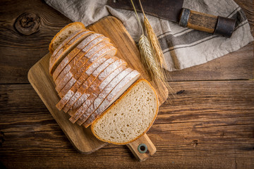 Sliced loaf of bread on a chopping board.