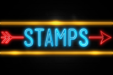 Stamps  - fluorescent Neon Sign on brickwall Front view