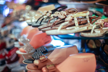 Store women's shoes summer collection with bokeh on blurred background