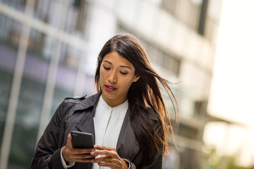 Businesswoman outdoors using smartphone