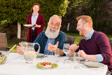 happy men sitting at table