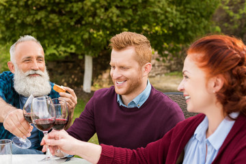 family clinking glasses of wine