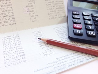 Business, finance, investment or accounting concept : Calculator and saving account book or...