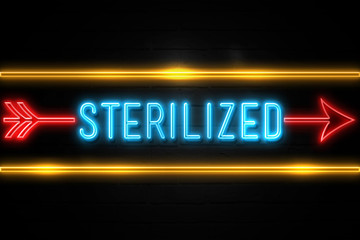 Obraz premium Sterilized - fluorescent Neon Sign on brickwall Front view