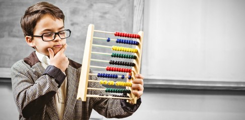 Pupil dressed up as teacher holding abacus - obrazy, fototapety, plakaty