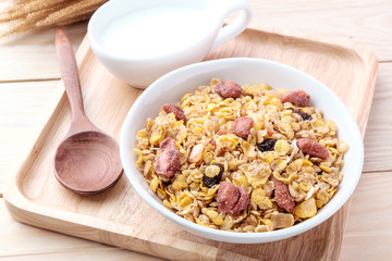 cornflakes and dry fruits on wooden background
