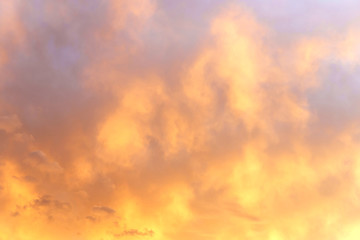 Naklejka na ściany i meble view on the beautiful orange sunset sky with clouds.