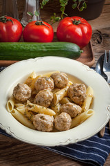 Pork meatballs with dill sauce and pasta. Selective focus.