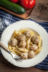 Pork meatballs with dill sauce and pasta. Selective focus.