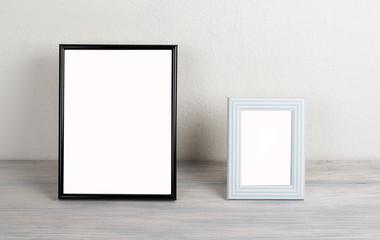 Photo frames on wooden table. Decor.