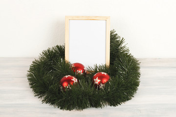 Photo frames next to christmas decoration on wooden table. Decor.