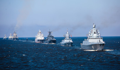 Fototapeta na wymiar A line of modern russian military naval battleships warships in the row, northern fleet and baltic sea fleet in the open sea