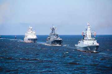 A line of modern russian military naval battleships warships in the row, northern fleet and baltic sea fleet in the open sea