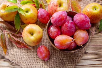 Ripe red apples and plums
