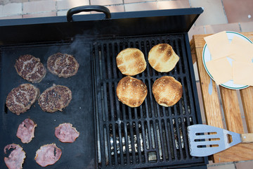 Beef Burgers And Spatula On The Hot BBQ Charcoal Grill, Close-up, Top View
