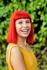 Happy red hair woman in a park