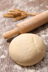 raw dough and rolling pin