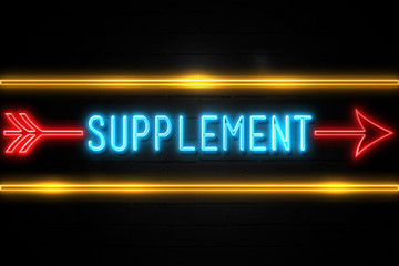 Supplement  - fluorescent Neon Sign on brickwall Front view